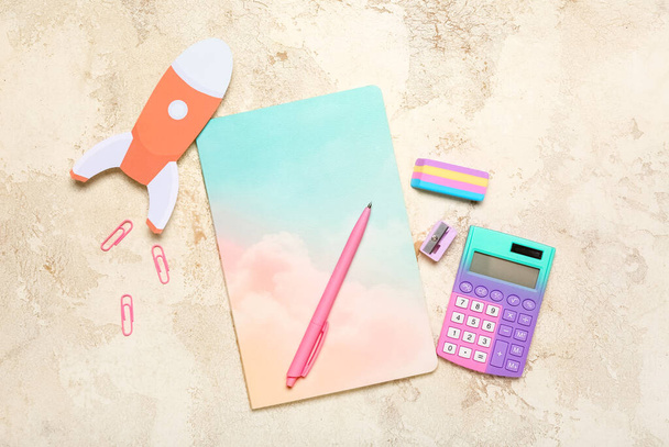 Paper rocket with school stationery on grunge background - 写真・画像