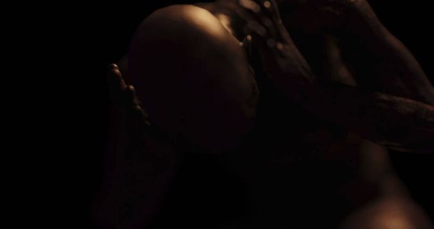 Image of distressed shirtless bald figure holding head in pain in dark room. Fear, horror and suffering concept digitally generated image. - Photo, image