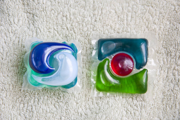 two detergent pods closeup. minimalism of detergent. laundry detergent. - 写真・画像