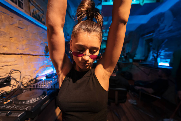 Beautiful female DJ dancing to techno - Photo, image