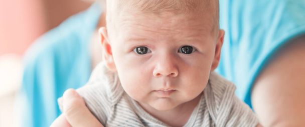 Close-up detail portrait of cute little peaceful newborn baby boy child face with beautiful open eyes. Love and family emotion - Fotoğraf, Görsel
