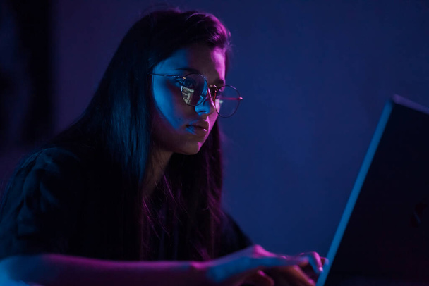 Attractive young woman working in home at night. Girl using laptop. - Φωτογραφία, εικόνα