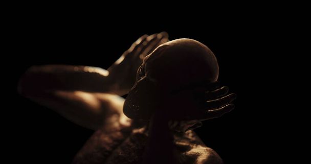 Image of distressed shirtless bald figure holding head in pain in dark room. Fear, horror and suffering concept digitally generated image. - Fotó, kép