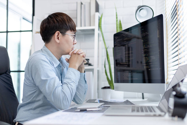 Professional development programmers are sit on a desk with work equipment such as: computer-laptop-tablet. for working in programming or writing code on  website,  HTML, javascript, Software. - 写真・画像