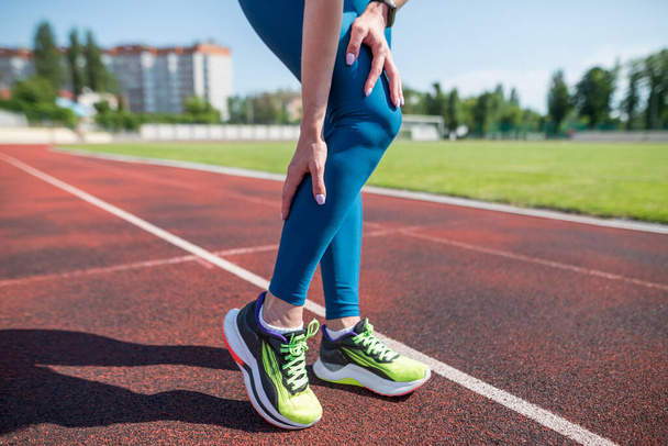 woman runner holding her sports leg injure.woman runner on treadmill and suffering from leg pain after running outdoors. - Fotoğraf, Görsel