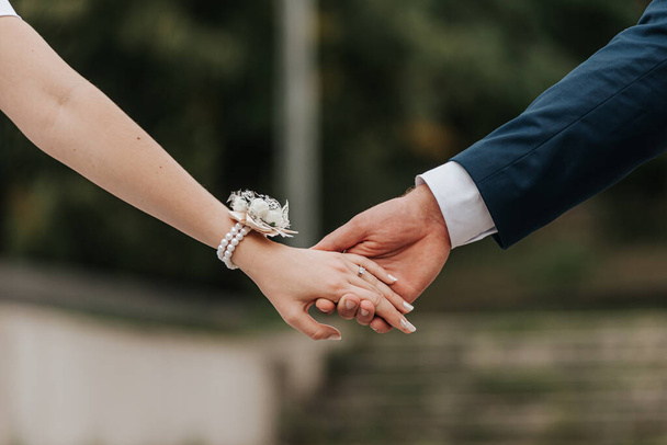 The two people holding hands at the wedding - Photo, Image