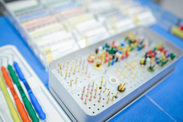 A closeup shot of a box of colorful tools for orthodontists and dentists - Photo, image