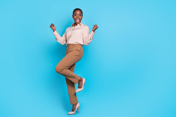 Full length photo of young beautiful lady worker raise fists in victory celebrate her personal achievements isolated on blue color background. - Foto, Bild