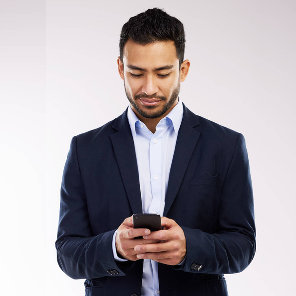 How well connected are you. Studio shot of a young businessman using a cellphone against a white background - Foto, imagen