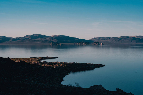 A scenic view of the Pyramid Lake in Nevada with the reflection of the sky on the surface - Fotó, kép