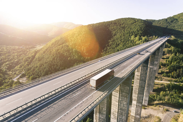 An aerial view of a cargo delivery truck on a highway - Fotoğraf, Görsel