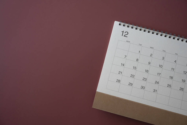 close up of calendar on the crimson table background, planning for business meeting or travel planning concept - Fotó, kép