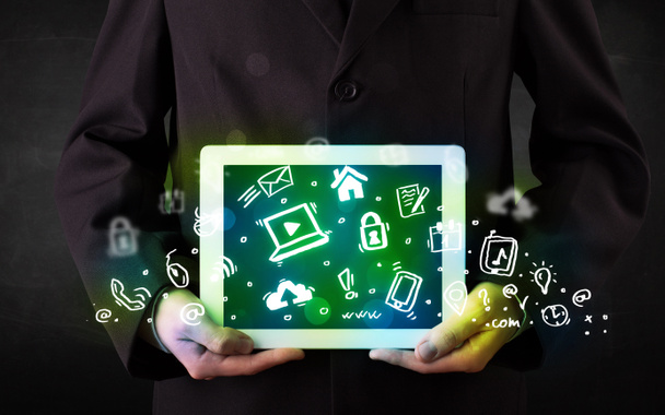 Person holding tablet with green media icons and symbols - Photo, Image
