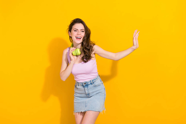 Photo of cheerful nice girl toothy smile look empty space arm palm waving hi isolated on yellow color background. - Photo, image