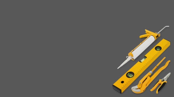 Construction work tools for building. Yellow hard hat with work equipment isolated on grey background. Layout for home service repair concept or hardware store showcase banner.Top view set of objects - Πλάνα, βίντεο