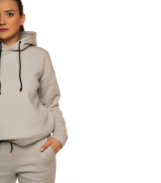 Half portrait of a young woman in tracksuit on white background. - Foto, imagen