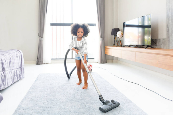 Portrait of child cute mixed race girls cleaning the floor in the bedroom at home by using a vacuum cleaner fun talks Expressing love for each other, concept growth, development, family relationships. - Fotoğraf, Görsel