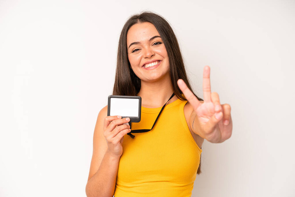 hispanic pretty woma smiling confidently pointing to own broad smile. vip pass id card concept - Fotoğraf, Görsel