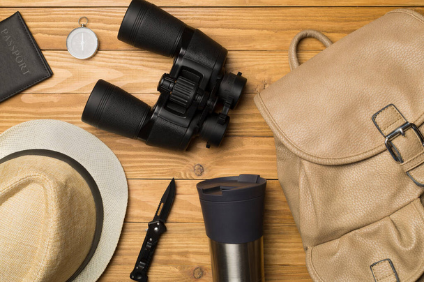 Travel accessories for mountain trip on wooden background, top view. - 写真・画像