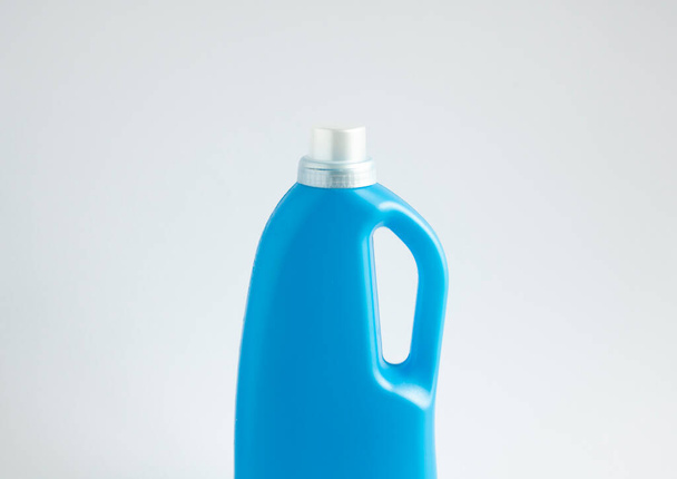 Blue plastic bottle with a grey cap isolated on white background for liquid detergent laundry or cleaning agent. Packaging template mockup - Photo, image