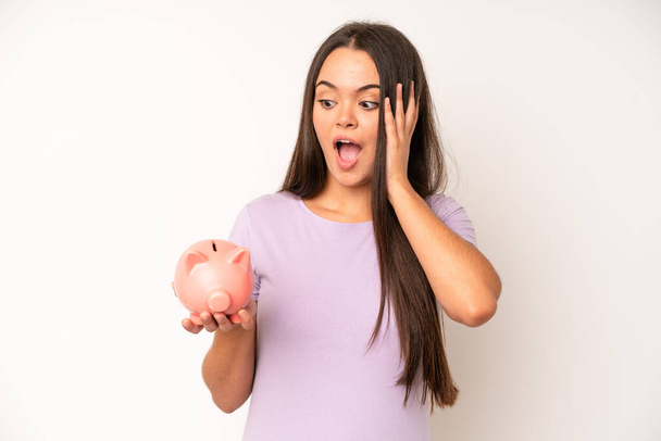 hispanic pretty woma feeling stressed, anxious, tired and frustrated. piggy bank savings concept - Fotoğraf, Görsel