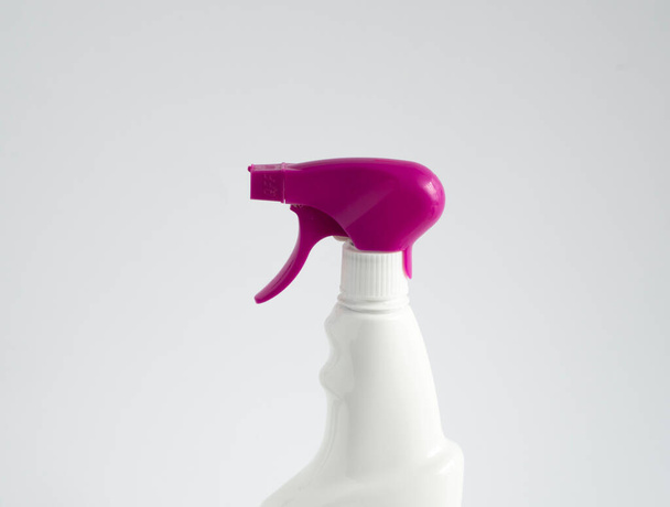 White blank plastic spray detergent bottle with a violet sprayer isolated on white background. Packaging template mockup - Fotografie, Obrázek
