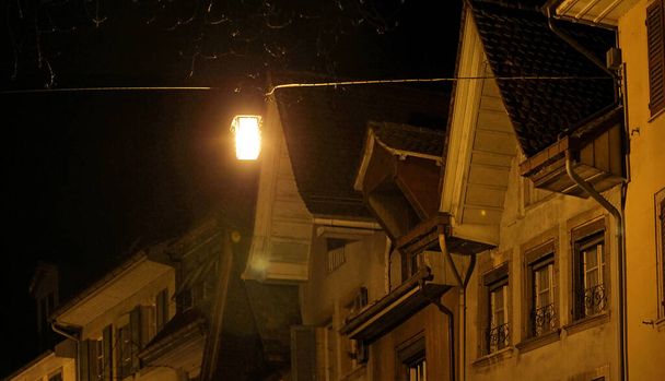 roofs of old city buildings at night - 写真・画像