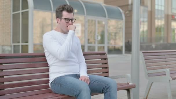 Casual Man Coughing while Sitting on Bench Outdoor - Filmmaterial, Video