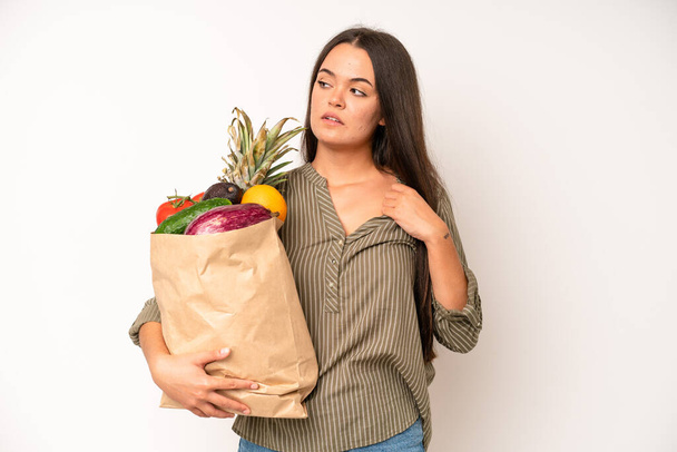 hispanic pretty woma feeling happy, surprised realizing a solution or idea. market vegetables bag concept - 写真・画像