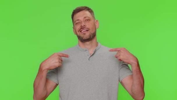 I am the best, choose me. Bearded handsome young man in feeling very proud pointing herself, looking self-confident, overjoyed by success. Adult guy isolated on chroma key studio background indoors - Séquence, vidéo