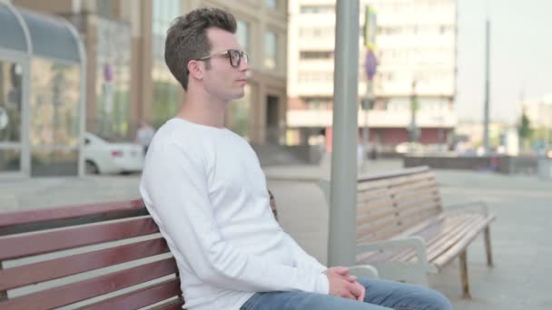 Casual Man Smiling at Camera while Sitting on Bench - Video