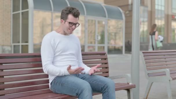 Angry Casual Man Feeling Frustrated while Sitting Outdoor on Bench - Metraje, vídeo