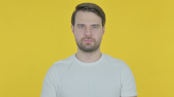 Serious Casual Young Man on Yellow Background  - Filmagem, Vídeo