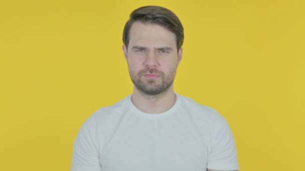 Rejecting Casual Young Man with Arm Gesture on Yellow Background  - Felvétel, videó