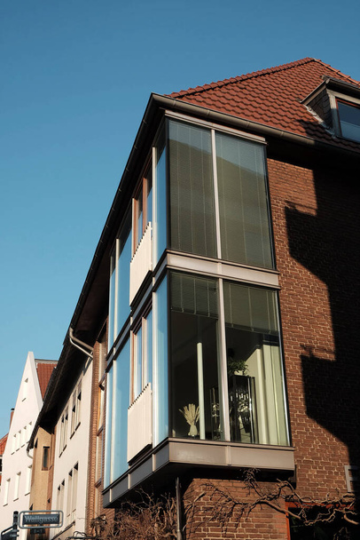 A vertical shot of a building with glass balconies - Zdjęcie, obraz