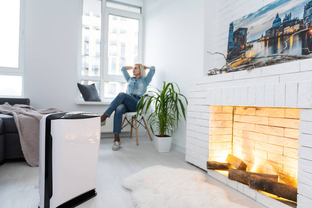 Woman In Living Room Using Air Cleaner And Humidifier. - Photo, Image