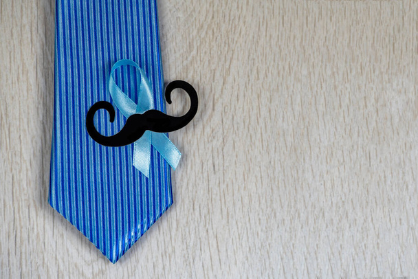 Blue ribbon with necktie on grey background.  - Фото, изображение