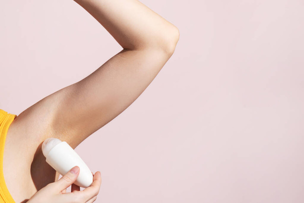 Lady Applying Antiperspirant Roll Underarms For Armpits Freshness. High quality photo - Foto, afbeelding