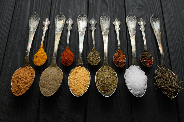 Colorful various herbs and spices for cooking on dark wooden rustic background - Foto, Imagem