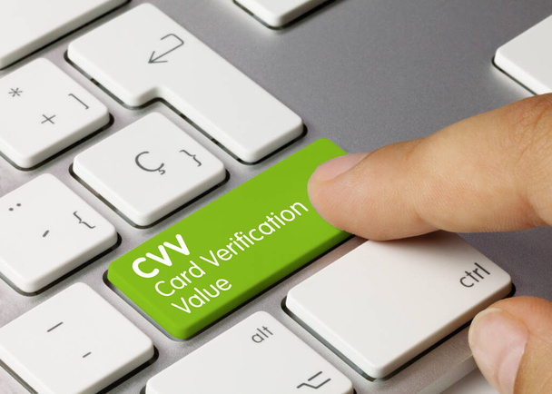 CVV Card Verification Value Written on Green Key of Metallic Keyboard. Finger pressing key. - Foto, imagen
