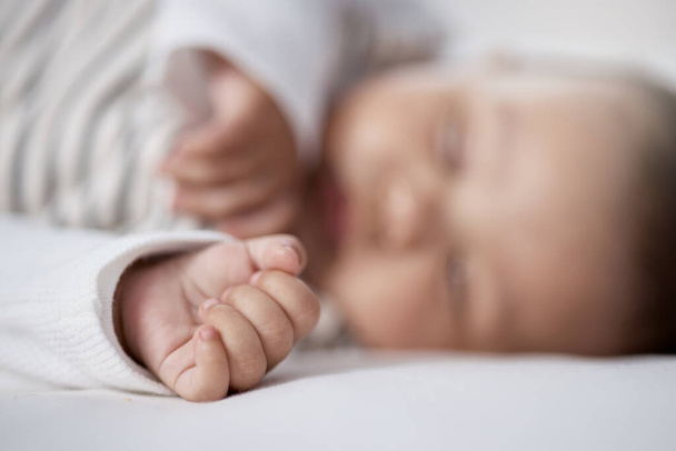 Babies need lots of sleep to grow. Closeup shot of a babys hand while asleep at home - Foto, imagen