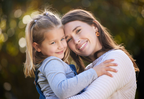 I will always hold her near and dear. Portrait of a mother and her little daughter bonding together outdoors - Foto, imagen