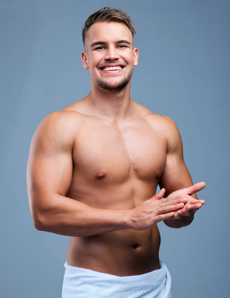 A true gentleman doesnt even need a suit. Studio portrait of a muscular young man posing in a towel against a grey background - Φωτογραφία, εικόνα