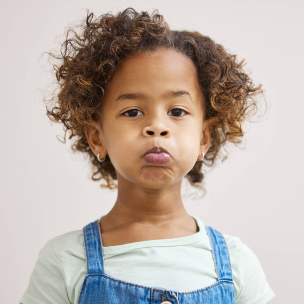 Oh, please. an adorable little girl standing alone and pulling a funny face - Foto, immagini