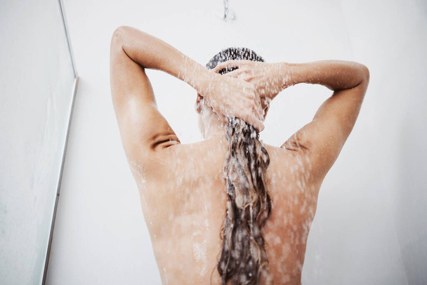 Rinse repeat and seal those cuticles. a woman washing her hair in the shower - 写真・画像