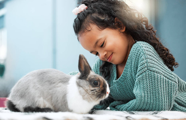 Spending time with my favourite pet. an adorable little girl bonding with her pet rabbit at home - Fotografie, Obrázek