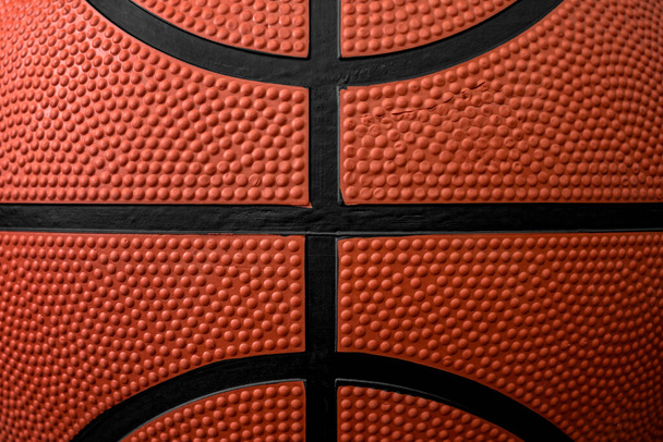 Zoom close up photograph on the bumpy details of a genuine rubber basketball concept for competitive sports backgrounds, athletic competition and sporting event wallpaper - Foto, Imagen