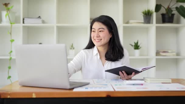 Asian business woman on a video call by laptop. Online meeting concept. - Video