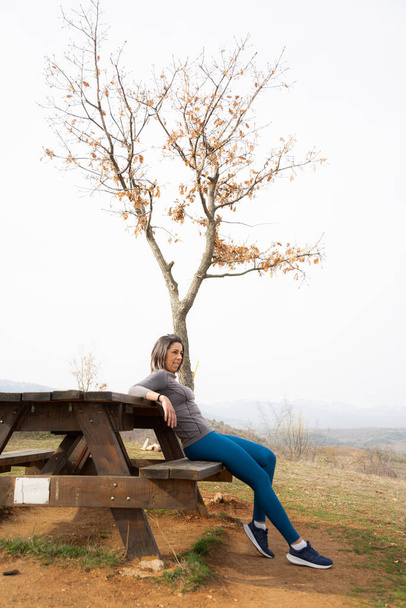 Amazing girl relaxing on a bench from working out - Φωτογραφία, εικόνα