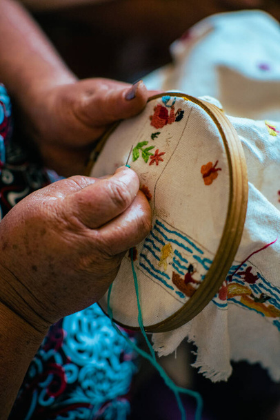 A vertical shot of the process of embroidery done by a professional embroider - Φωτογραφία, εικόνα